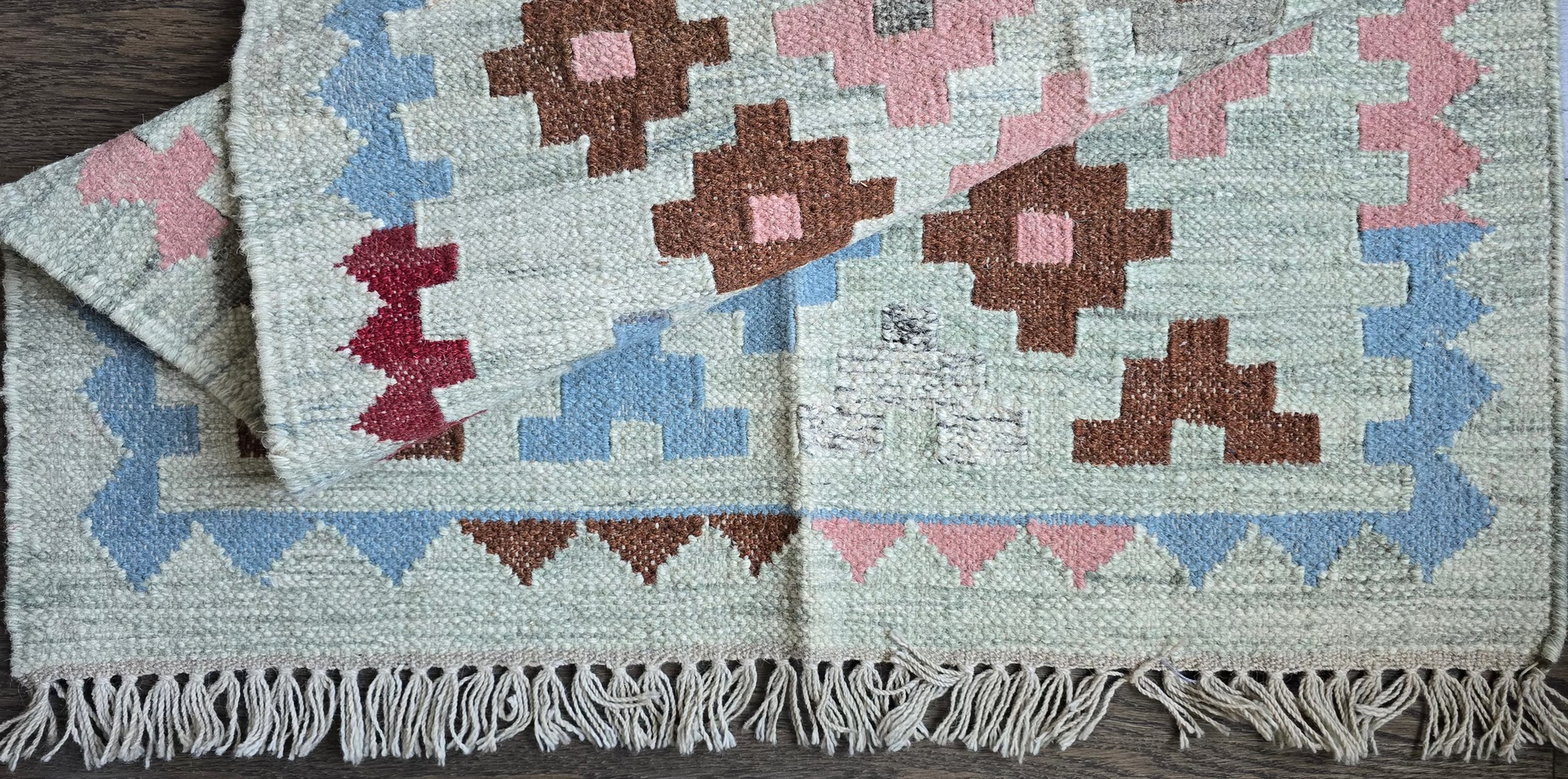 Set of patterned rugs with geometric designs on a wooden floor.