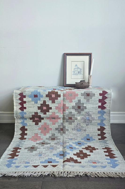 Decorative rug with geometric pattern on a plain background